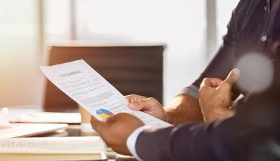 Person Reading Paperwork in an Office